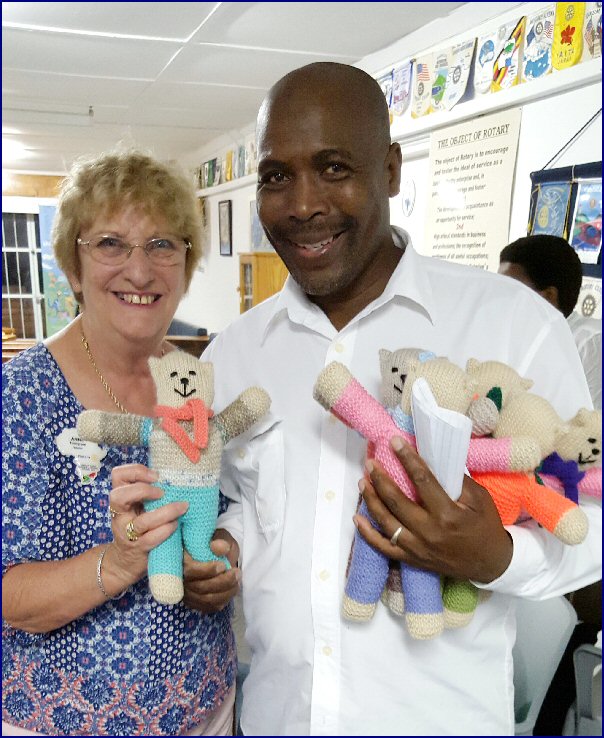 Photograph: Anne Thompson Rotarian ( Lutterworth Rotarian, Rose Chapman’s sister) and Director of a local children’s home in South Africa presenting Teddies for the children.